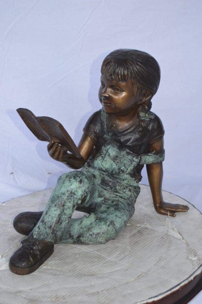 Young Girl Laying and Reading Book Bronze Statue - Size: 18" L x 9" W x 16" H.